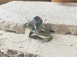 Our large facet cut emerald is set in a simple sterling silver bezel to show off the beauty and size of the stone, which is frankly huge. And it's a beautifully even, deep coloured stone as well. This is a statement ring that can be worn be either men or women. Measurements: Emerald 2.5 x 1.7 cm Size 8.5 | 18.75 mm