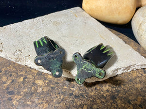 Bronze hands of Buddha that can be oriented up, sideways or downward facing. Hand cast from solid brass with a diamond shaped lotus viswa vajra in the centre of each palm and highlighted with a light green pigment. The hands have three attachment points. These make beautiful door, cupboard or drawer handles, and also work as pegs. Price is for one pair. Measurements: 9 cm (3.4") length