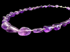 Striking but simple graduated boulder amethyst necklaces with sterling silver bead detailing, finished with a sterling silver hook clasp.