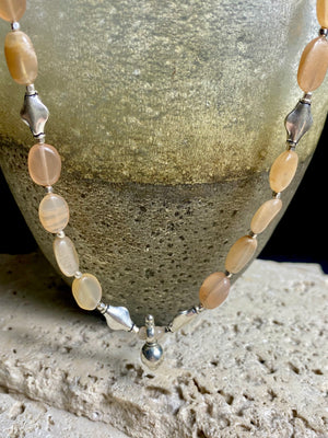 Long necklace made from apricot moonstone with handmade sterling silver Indian beads and centrepiece. A lovely necklace for any occasion. Length: 57.5 cm