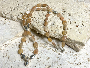 Long necklace made from apricot moonstone with handmade sterling silver Indian beads and centrepiece. A lovely necklace for any occasion. Length: 57.5 cm