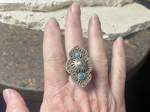 beautiful statement ring made by a Rajasthani village silversmith just outside of Jaipur. Sterling silver and blue ceramic beads with hand wired (not cast) filigree face decoration. Rajasthan, India. Looks great on a man's hand or woman's hand. Measurements: Face 4 cm x 2.5 cm Size 9.25 | 19.25 mm