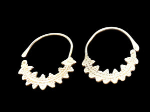 Berber open hoop earrings with ornamented crescent edged with trefoil projections. High grade silver. Tunisia. Early 20th C. Height 4.1 cm, width 3.7 cm