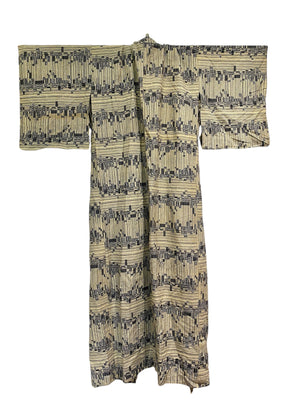 Vintage man or woman's full length Japanese kimono dateing to the 1950s. Silk, hand stitched. Blue black geometric pattern on a cream background.