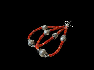 Long, bold southwest earrings of heshi coral highlighted with antique silver Rabari beads, sterling silver beads and hooks. Natural, sustainable bamboo coral, 10.5 cm length