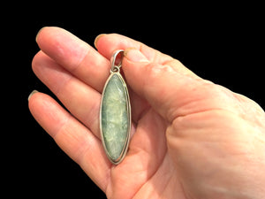 Long emerald pendant, frosted light green colour, facet cut, set in a shadow box mounting of sterling silver. Large bail. Height 6 cm, width 1.7 cm.