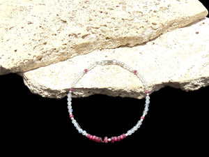 Fine beaded bracelet of facet cut ruby and round rainbow moonstone beads, finished with sterling silver beads and clasp. Length 20.6 cm, size 19 cm
