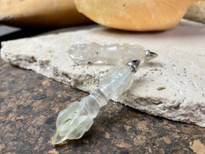 Hand carved rock crystal dorje or vajra pendants. Top mounted sterling silver bail. Approximately 6 cm in length and carved from Himalayan quartz.