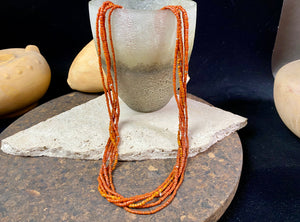 Our long tribal multistrand necklace is made with antique ceramic beads worn by the Bonda people of the Himalayas. This five strand red-brown-orange necklace is finished with a handmade sterling silver clasp and features sterling silver bead detailing. Measurements: 66 cm length