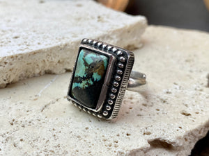 Silver tribal ring, set with a large antique Tibetan turquoise stone. This substantial heavy ring weighs almost 15 grams. Will suit either men or women. Afghanistan. Measurements: Ring face 2.2 x 2 cmInner diameter 17.5 mm | Size 7, however this is an adjustable ring that will fit any finger from size 6 to 8.