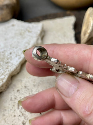 Mid 20th century Ethiopian silver crucifix. This may have been cut from a Marie Therese silver thaler, as the antique ones always are, however I believe that the style is more recent. Tests as silver. Plain on front side, plain back. Some wear at the head of the bail commensurate with its age. A wearable and collectable piece of jewellery. Measurements: length including bail 6 cm