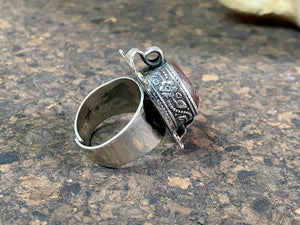 Afghani ring features a large carnelian stone carved with the images of two birds. Medallions of brass, silver loops and an embossed band complete the decoration. This large silver ring sits high on the finger and is statement jewellery. Adjustable ring, inner diameter 18 mm | Size 7.75 | No 17