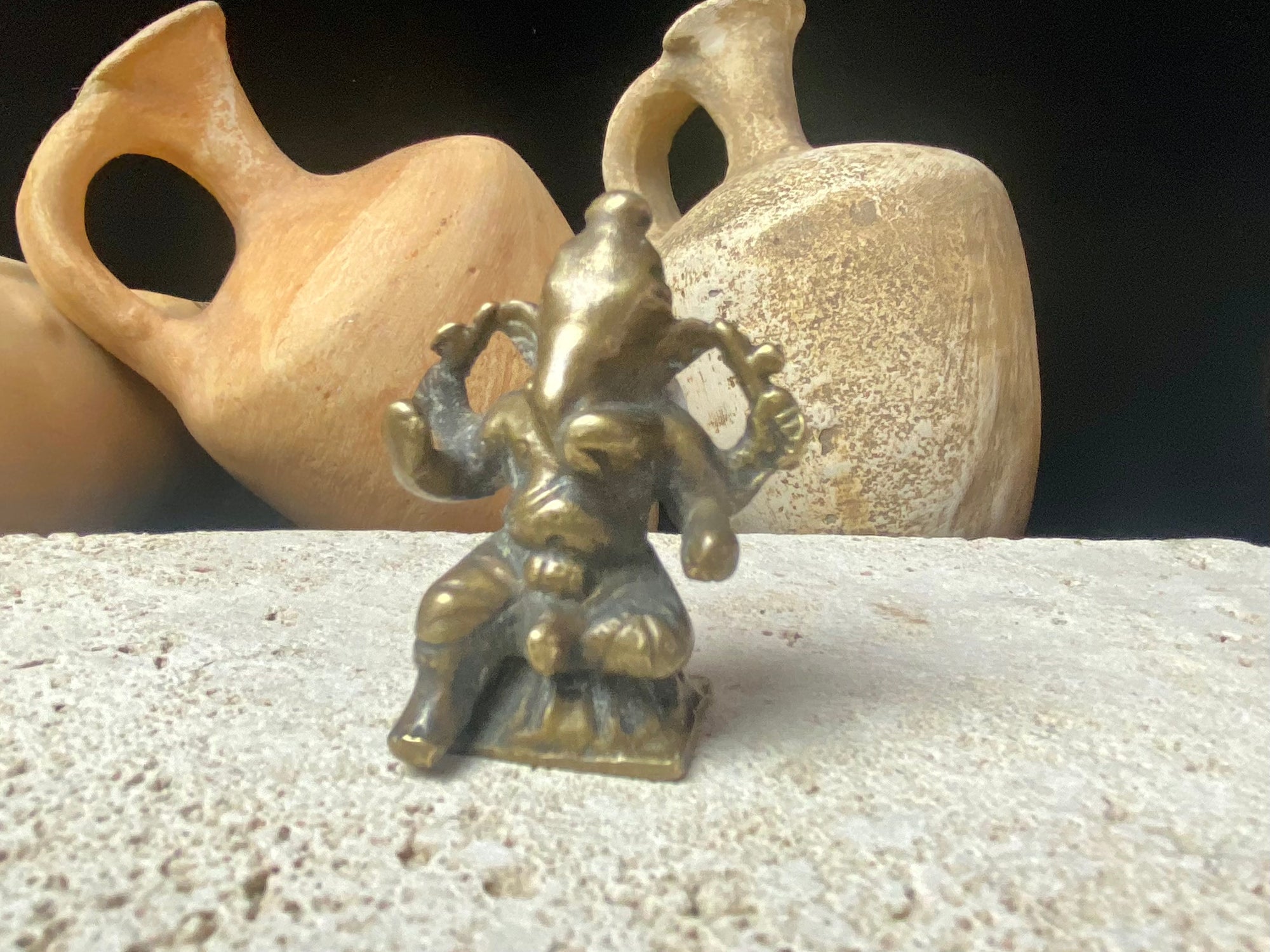 This exquisite mini Ganesh statue features fine, elegant features, and a face softened by many years of rubbing and worship. A beautiful piece. Approximately 100 years old, early 20th century, India, brass alloy.  Measurements: height 6.5 cm, width 3.2 cm, depth 2.5 cm
