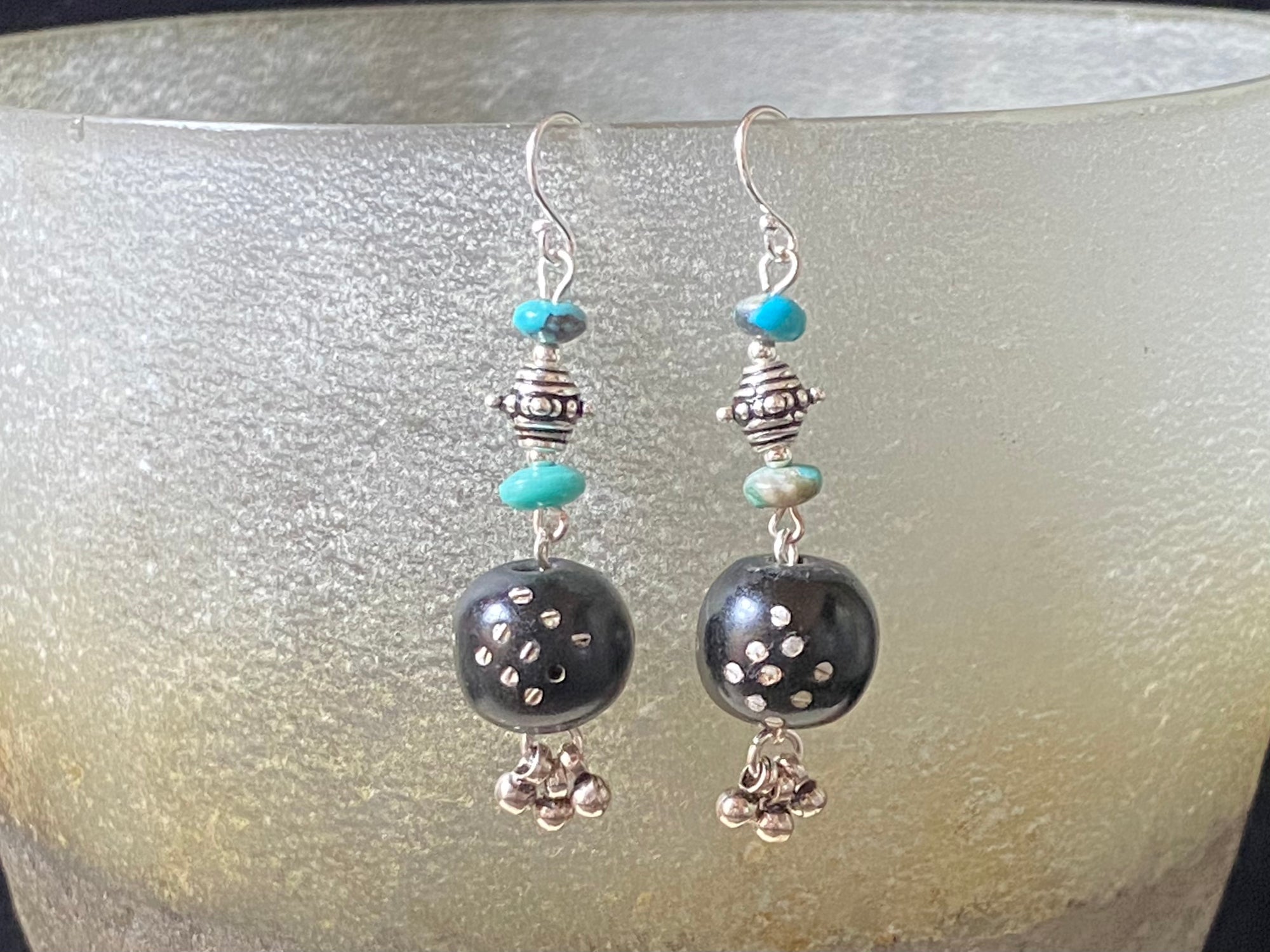 These statement earrings were created from vintage Yemeni black wood beads inlaid with silver. They are finished with Arizona turquoise and sterling silver handmade beads & hooks. A one-off earring design that's light and easy to wear. Length 5 cm including hook, and the inlay beads are approximately 12 mm in length.