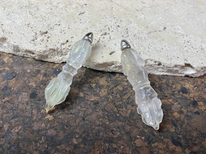 Hand carved rock crystal dorje or vajra pendants. Top mounted sterling silver bail. Approximately 6 cm in length and carved from Himalayan quartz.