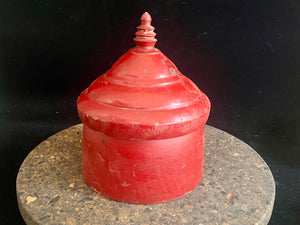 Large red lacquered tikka pot or tikka boxes. Hand carved from single hollowed out pieces of teak, these lidded pots traditionally hold the red vermillion (bindi) powder used for marking the forehead during Hindu ceremonies. They date to the early 1900s. Measurements: approximate diameter 12-14 cm, height 16-18 cm