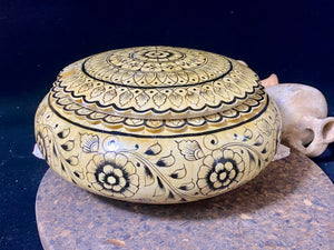 A beautiful low oval lidded bowl or box, traditionally called an opium pot because of its shape. Crafted from hand shaped panels of camel bone over wood, then hand painted. Hand made in Rajasthan, India. Measurements: diameter 24.5 cm, height 10 cm.