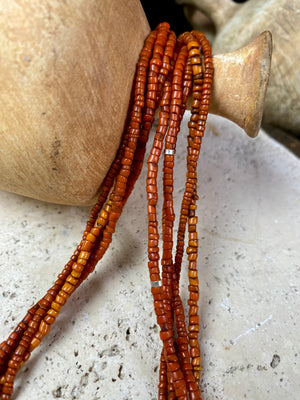 Our long tribal multistrand necklace is made with antique ceramic beads worn by the Bonda people of the Himalayas. This five strand red-brown-orange necklace is finished with a handmade sterling silver clasp and features sterling silver bead detailing. Measurements: 66 cm length