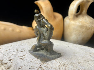 A small cast brass Hanuman in forward kneeling style. This piece has some rubbing on the face, shows a naturally darkened patina and is approximately 80 years old, although it may be older. Gujarat, India.    Measurements: height 6 cm