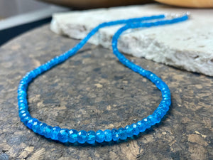 Short dark blue apatite necklace featuring graduated faceted apatite beads finished with a sterling silver lobster clasp. This is a lovely statement necklace that matches any skin tone or clothing. These stone are natural and not heat treated Measurements: 39.7 cm total length