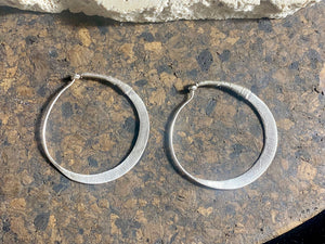 Beautiful hand beaten sterling silver hoops with wrapped silver wire detailing. Waziri, from Afghanistan. Measurements: outside diameter of hoop approximately 4.6 cm