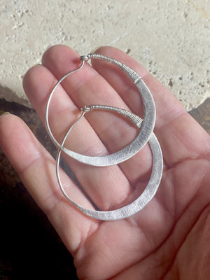 Beautiful hand beaten sterling silver hoops with wrapped silver wire detailing. Waziri, from Afghanistan. Measurements: outside diameter of hoop approximately 4.6 cm