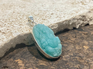 Hand carved gem quality translucent amazonite carved as n image of Ganesh. height 4.1 cm including bail.