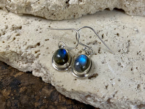 Simply elegant oval earrings with a small shadow box bezel to show off the beauty of the natural cabochon gemstones. Sterling silver hooks complete the look. Our earrings are open-backed to allow the light of the stones to show through. Length including hook 2.5 cm