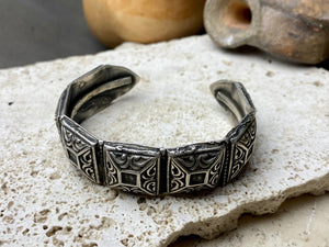 A modern interpretation of an antique style of bracelet, this fine cuff is hand crafted from sterling silver by Rajasthani silversmiths. Exquisitely detailed, the oxidised finish shows off the workmanship beautifully. There is some small room for movement in this cuff, and it is designed to fit an average sized wrist.  Measurements: Inside opening is 6.5 cm, with room for expansion or contraction