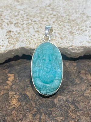 Hand carved gem quality translucent amazonite carved as n image of Ganesh. height 4.1 cm including bail.