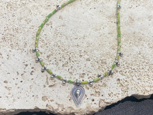 This very pretty necklace is made from tube cut imperial green jasper, highlighted with traditional handmade sterling silver Rajasthani ball beads and a tribal pendant. Finished with sterling silver findings and hook clasp. The pendant represents the shiva lingam/yoni. Length 40.5 cm
