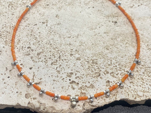 Fine cut beads of bamboo coral, highlighted with traditional handmade sterling silver Rajasthani ball beads. Finished with sterling silver findings and hook clasp. Designed to be unisex, this necklace would look stunning on men and women. Measurements: 41 cm (15.85")