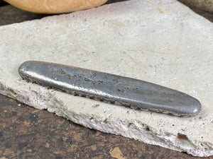 Silver 1.5 Tamlung Lat (short for talat, or currency), often called tiger tongue money, with 3 na (snake) marks. Circa 1591-1707. Laos Vientiane.  This is a hand poured silver ingot with its original patina. Length 11.8 cm