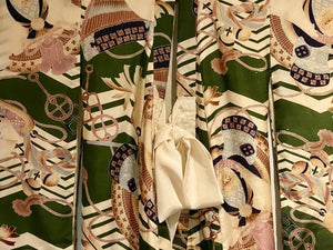 Small, hand sewn child's kimono suitable for either sex. A tasteful design features greens, tans, navy, lilac and pale blue colours in an abstracted design reminiscent of its era. Padded and lined. Hand stitched silk ties with fine thread tassel detailing. No damage, excellent condition. Circa 1950's.