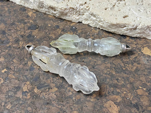 Hand carved rock crystal dorje or vajra pendants. Top mounted sterling silver bail. Approximately 6 cm in length and carved from Himalayan quartz.