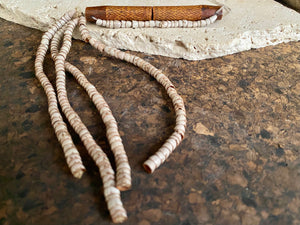 This is a vintage wood sewing needle case from northern Thailand, from the Ahka tribe. This beautiful, old and rare vintage piece is highly decorated and made from bamboo, etched, stained with red betel juice and finished with a long fringe of Jacob's tears. Length 24.5 cm with fringe, length of tube 9 cm