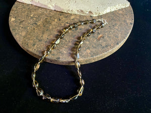 This simple necklace is crafted from high quality, tumbled and naturally dark smokey quartz stone and highlighted with sterling silver spacer beads. Finished with sterling silver ends. Measurements: Total length including clasp 50.5 cm