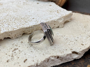 Silver tribal ring, set with a large antique Tibetan turquoise stone. This substantial heavy ring weighs almost 15 grams. Will suit either men or women. Afghanistan. Measurements: Ring face 2.2 x 2 cmInner diameter 17.5 mm | Size 7, however this is an adjustable ring that will fit any finger from size 6 to 8.
