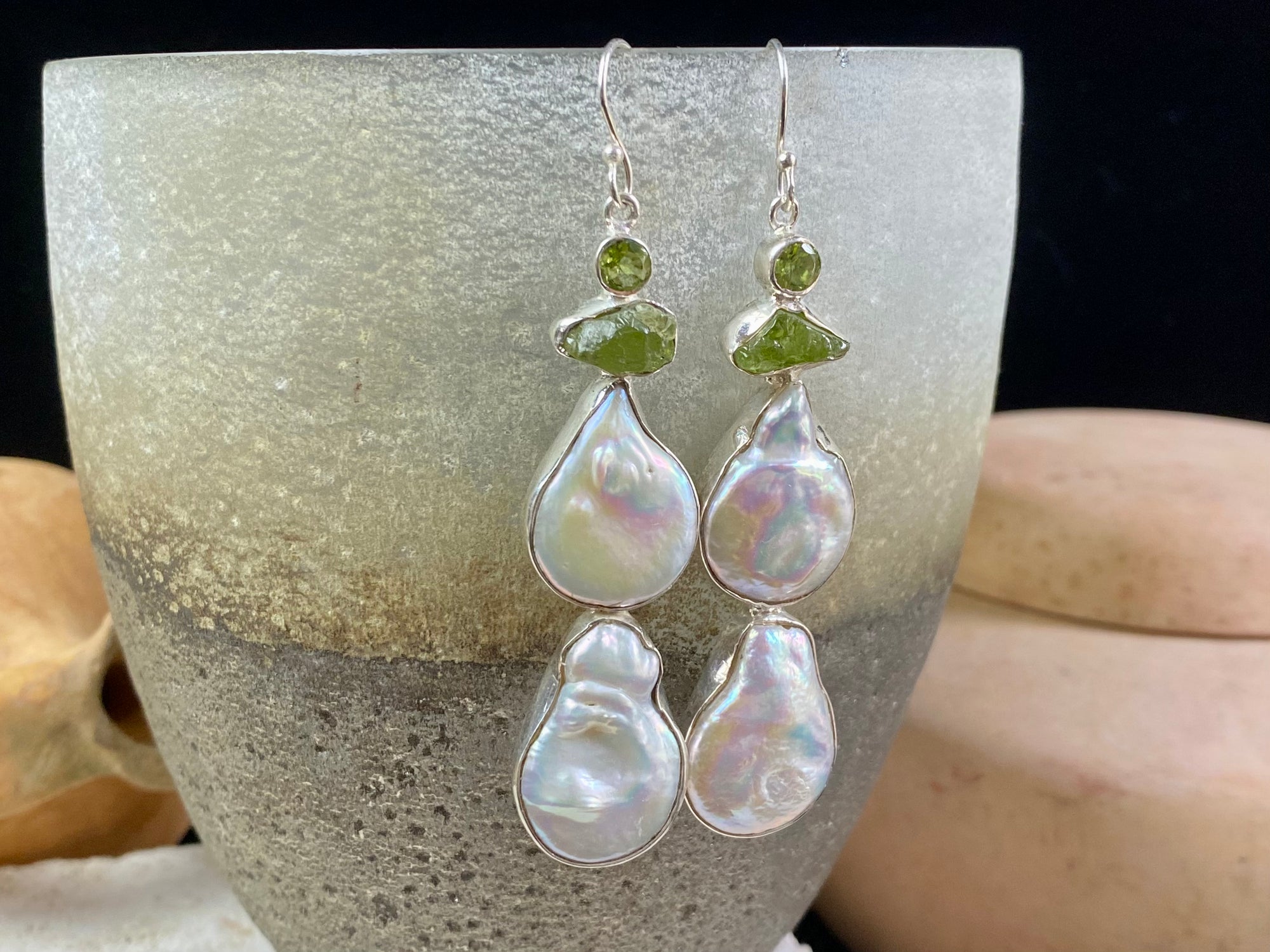 Very long earrings featuring cultured baroque pearls and peridot stones. These statement earrings are set in sterling silver, with sterling silver shepherd hooks. 8 cm length including hooks, width approximately 1.8 cm, depth 0.5 cm