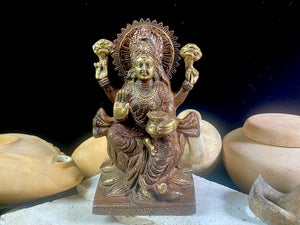A statue of the goddess Laxmi (or Lakshmi), Hindu goddess of wealth and prosperity. Cast from solid brass, her features are exquisitely detailed, while her face, hands and feet are polished. Her right hand is raised in the gesture of protection and her left hand holds a pot symbolising abundance. Measurements: 19.8 cm height, width12 cm, depth 8.3 cm