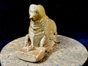 A very old, antique carving of Nandi, Lord Shiva's mount, decked with flower garlands. A small shiva lingham sits in front of him. This piece has seen some wear. But it is still very much Nandi, beloved companion of Shiva. Teak hardwood. Late 19th century. Measurements: length 18 cm, width 8 cm, height 14 cm