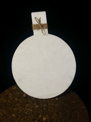 Our simple marble plate is designed for serving nibbles or for use as a cheeseboard. However, its simplicity means that it would also make a very nice plant or object stand. Hand carved in Rajasthan from white marble. A simple handle with hole for hanging completes the look. Measurements: length 29 cm, 21.5 cm disk diameter
