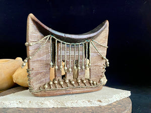 Kambatta wood headrest, Ethiopia. Early 1900's. Heavily carved and beaded. Dark patina and smooth wear on this piece are appropriate to its age. Measurements: height 16 cm (7"), width 18 cm