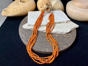 Vintage Naga long multistrand necklace made up of old ceramic beads with wrapped cotton ends and a coin button as fastener.  Measurements: 74 cm length