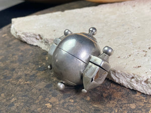 This Shiva lingam box or container is is a fine example of casket workmanship. Dating from the early 20th century or earlier, it is hand cast from high-grade silver & features wear marks commensurate with a piece this age. Measurements: Height 4.8 cm (1.85"), width 5 cm (2")