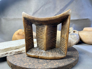 Old Oromo tribe wooden headrest from Ethiopia. Carved from a single piece of wood. Pre 1950. The patina and wear on this piece are appropriate to its age. In particular, note that the upper surface is darkened from use and the leading front edge is both lower than the rear edge and is also smooth from use.