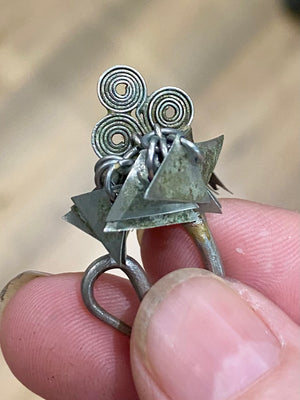Golden Triangle Hmong silver earrings. Laos. Early 20th century. While the geometric dangles are a personal representation of taste, the inner part of the earring has the classic trilobate shape that mimics part of the poppy and other fruit.
Height 3.5 cm