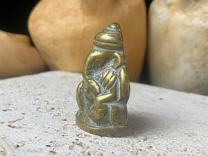Pocket Ganesh statue cast in brass, with both hands resting on his knees. This is a beautiful compact casting, ideally suited to a small altar or display, or for carrying in a pocket or bag. Our Ganesh has some age, and is a vintage piece, approximately 40 years old or older. Height 4 cm.