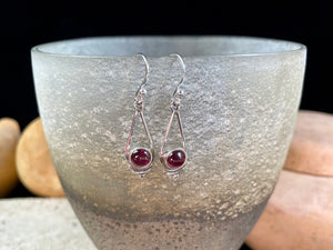 Simply elegant earrings with an art deco style, crafted from natural cabochon gemstones. Sterling silver surrounds and hooks complete the look. Length including hook 4.7 cm