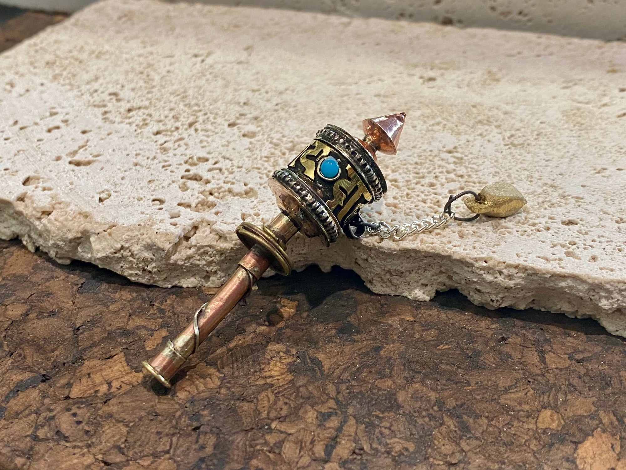 Miniature Buddhist prayer wheel. Copper and brass. Prayer scroll is written with the mantra Om Mani Padme Hum. Length 6.5 cm